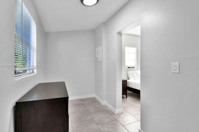 hall featuring light tile patterned floors and a wealth of natural light