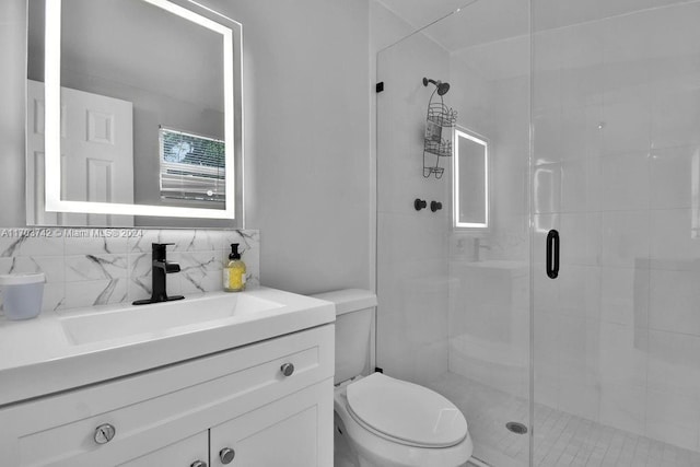 bathroom with decorative backsplash, toilet, walk in shower, and vanity