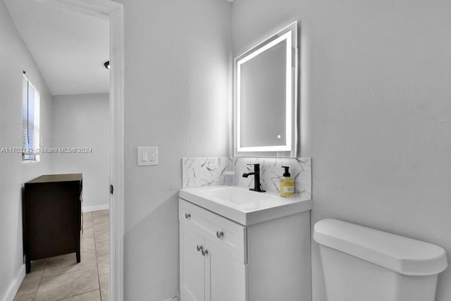 bathroom with vanity, backsplash, tile patterned floors, and toilet