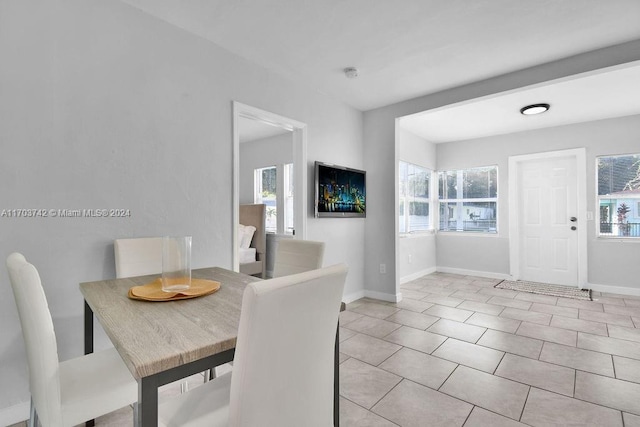 dining space featuring light tile patterned flooring