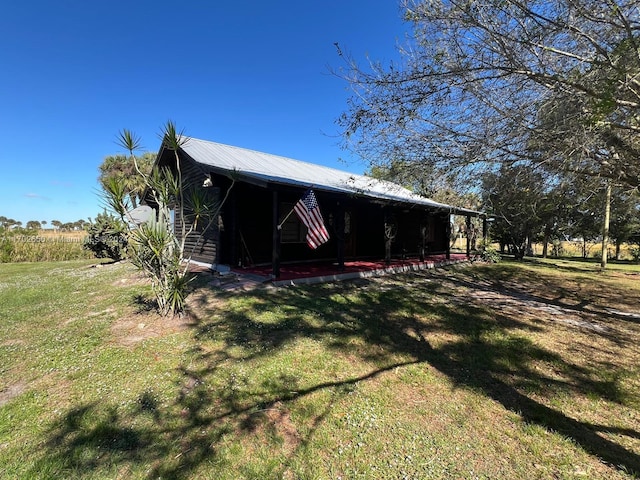 back of house with a lawn