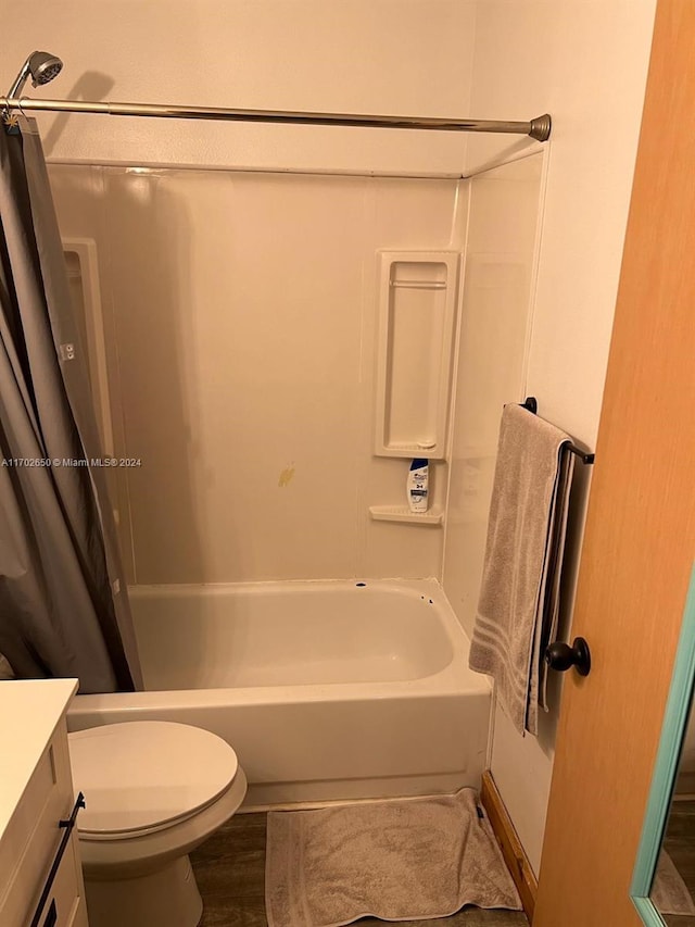 full bathroom featuring shower / tub combo with curtain, vanity, wood-type flooring, and toilet