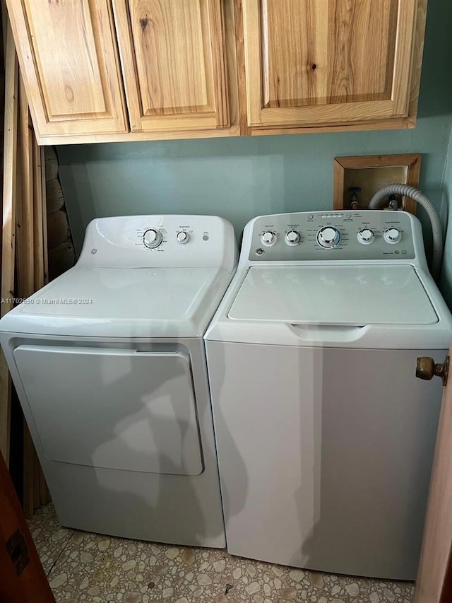 laundry room with cabinets and washing machine and dryer