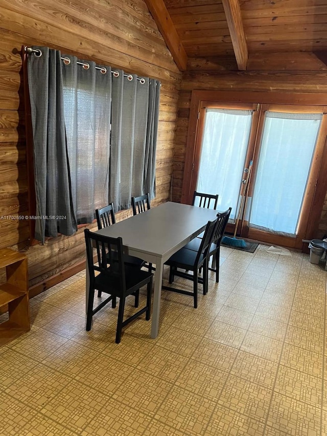 dining room with lofted ceiling with beams and wood ceiling