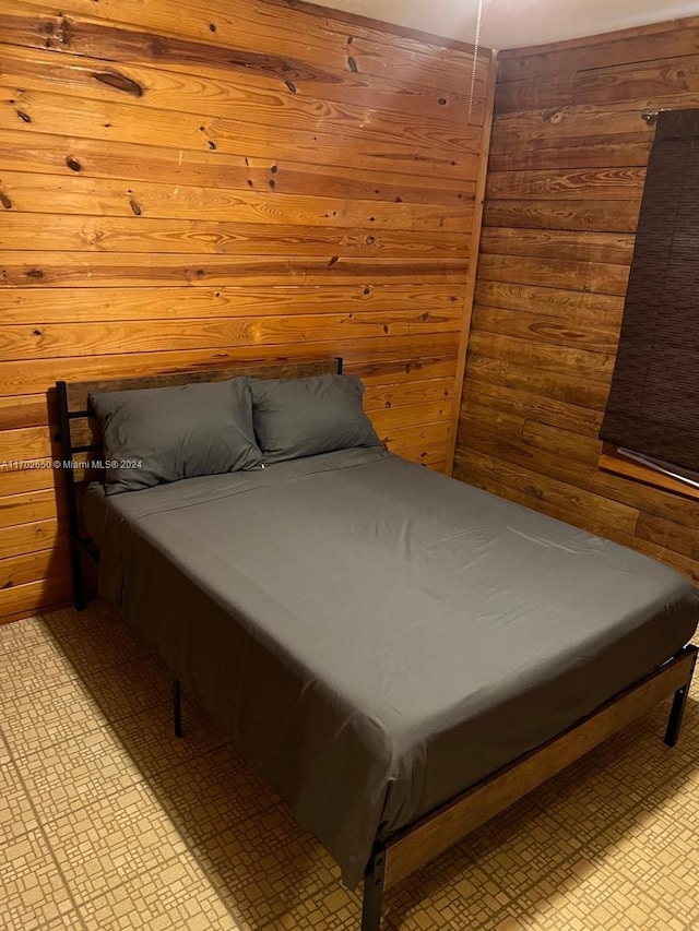 bedroom featuring wood walls