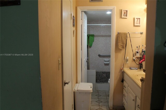 677 SW 9th Ave Unit 103, Miami, FL 33130 - bathroom featuring toilet, vanity, a shower, and tile patterned floors
