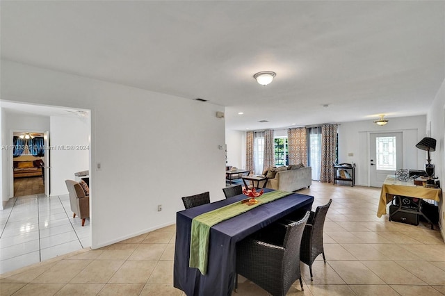 tiled dining area with ceiling fan