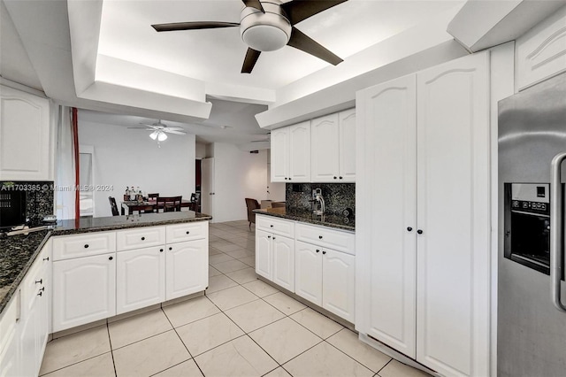 kitchen with dark stone countertops and white cabinets