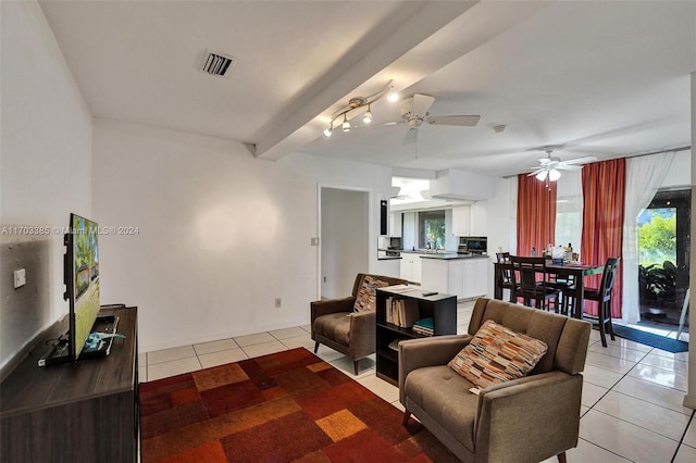 tiled living room with beam ceiling and ceiling fan