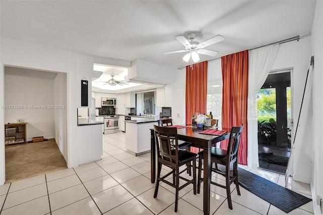 dining space featuring ceiling fan and light tile patterned floors