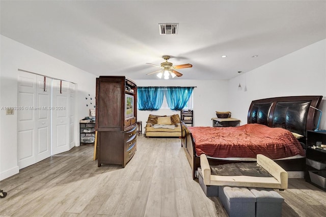 bedroom featuring light wood-type flooring, a closet, and ceiling fan