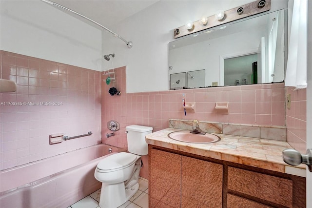 full bathroom featuring tile patterned floors, vanity, tile walls, toilet, and tiled shower / bath