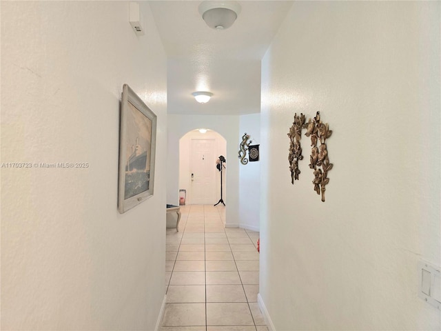 corridor with light tile patterned flooring