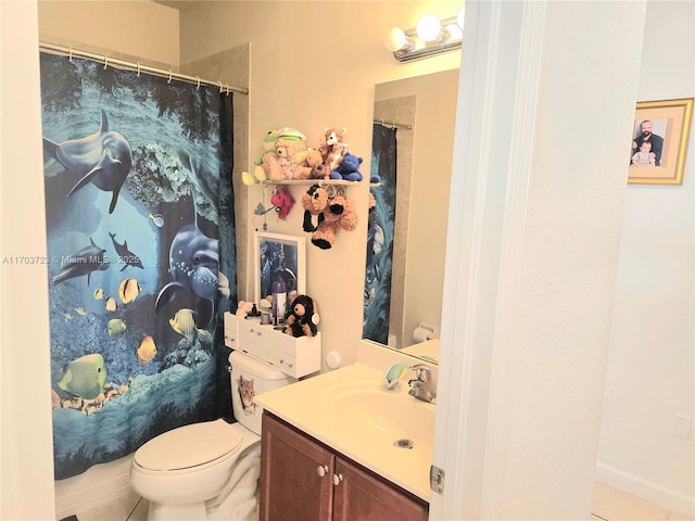 bathroom featuring tile patterned floors, vanity, and toilet