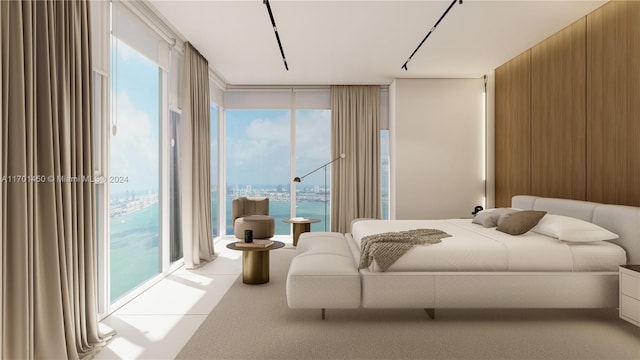 bedroom with a water view and multiple windows