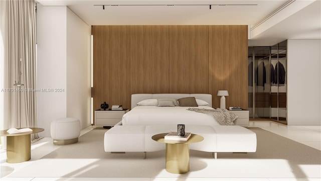 bedroom featuring a closet and wooden walls