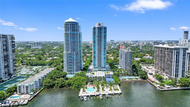 drone / aerial view featuring a city view and a water view