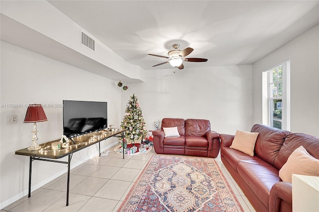 living room featuring ceiling fan and light tile patterned floors