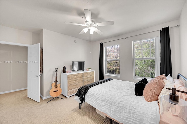 bedroom with ceiling fan and light colored carpet