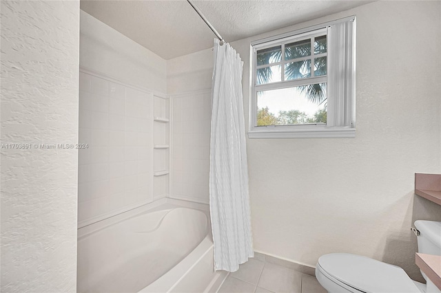 bathroom with tile patterned floors, shower / tub combo, a textured ceiling, and toilet