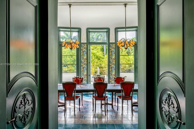 interior space featuring a healthy amount of sunlight and a notable chandelier