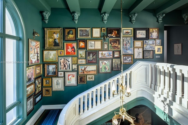 staircase with beamed ceiling