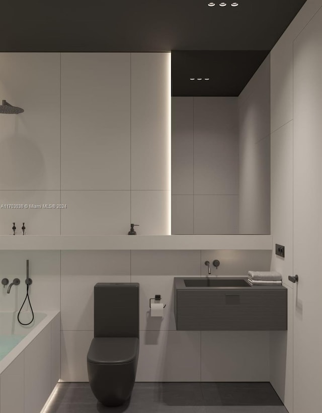 bathroom with vanity, a bath, and tile walls