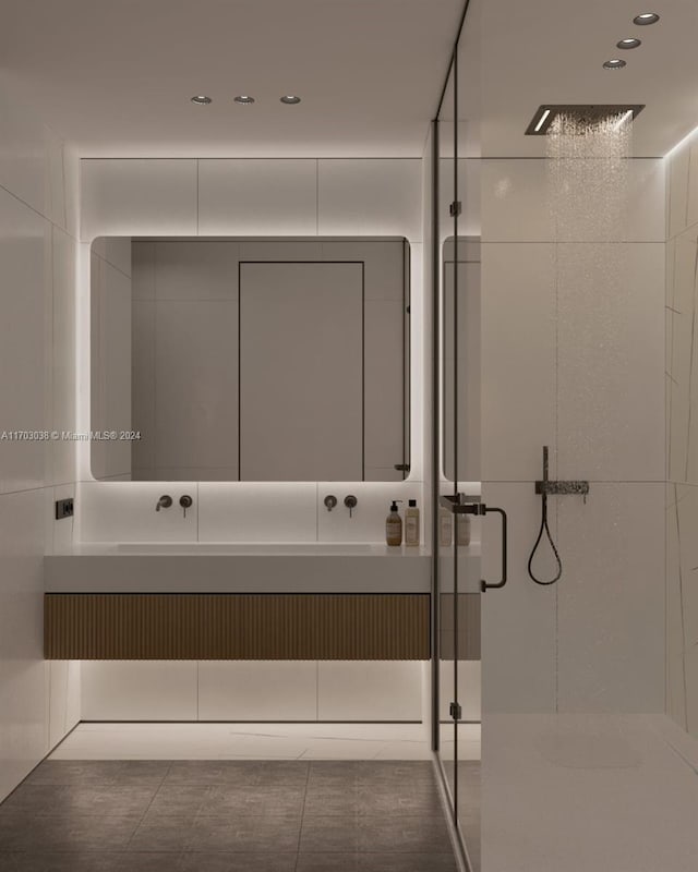 bathroom featuring tile patterned flooring, vanity, and a shower with shower door