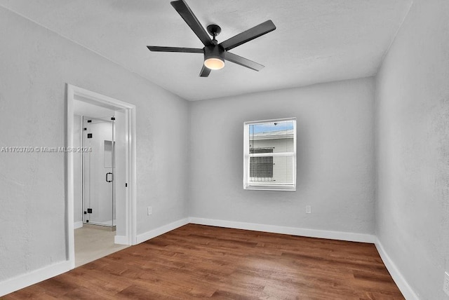 unfurnished room featuring ceiling fan and hardwood / wood-style flooring