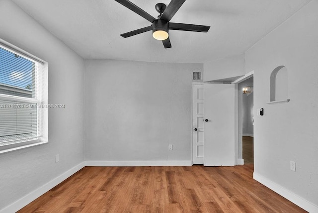 spare room with light wood-type flooring and ceiling fan