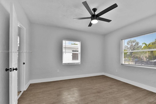 unfurnished room featuring dark hardwood / wood-style flooring and ceiling fan