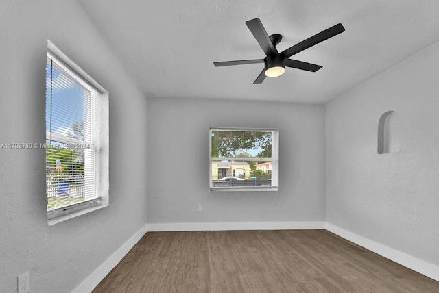 empty room featuring hardwood / wood-style flooring and ceiling fan