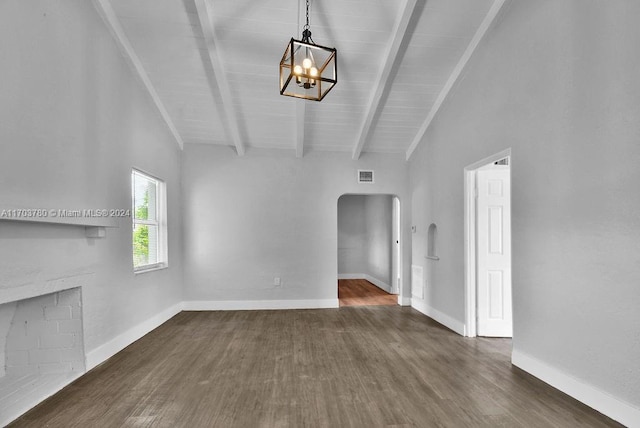 unfurnished living room with a chandelier, lofted ceiling with beams, wood ceiling, and dark wood-type flooring