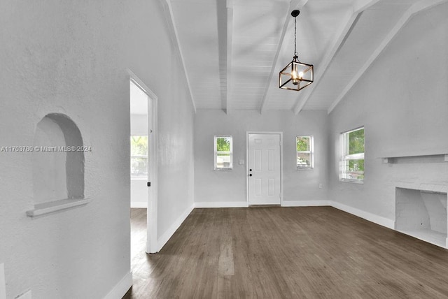 foyer featuring a chandelier, dark hardwood / wood-style flooring, and vaulted ceiling with beams