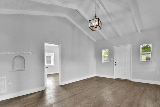 foyer with lofted ceiling with beams, a healthy amount of sunlight, and dark wood-type flooring