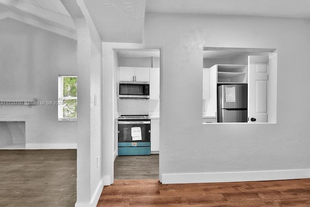 kitchen featuring white cabinetry, dark wood-type flooring, and appliances with stainless steel finishes