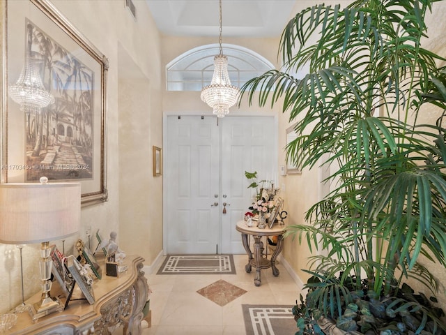 foyer entrance featuring tile patterned floors and an inviting chandelier