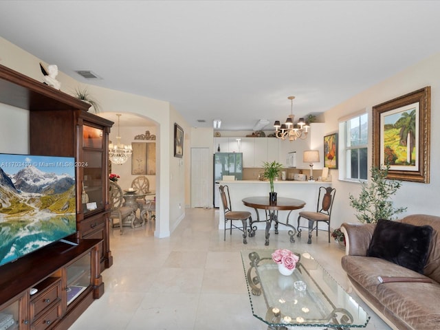 living room with light tile patterned floors and a chandelier