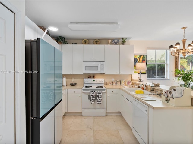 kitchen featuring white appliances, sink, an inviting chandelier, white cabinetry, and hanging light fixtures