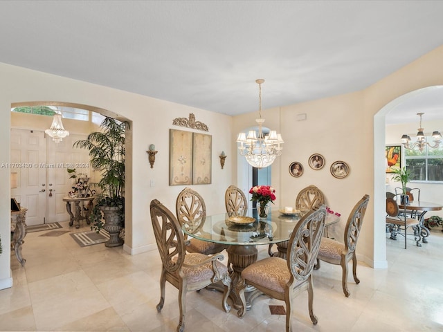 dining area with a healthy amount of sunlight and a notable chandelier