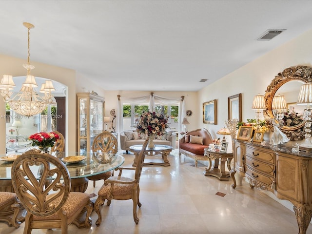 tiled dining area with a chandelier