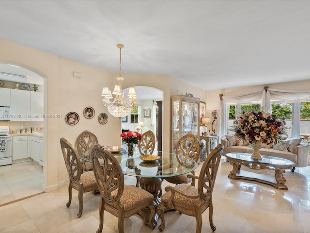 tiled dining space with a chandelier