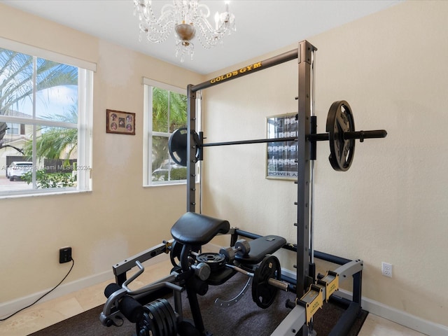 workout room featuring an inviting chandelier