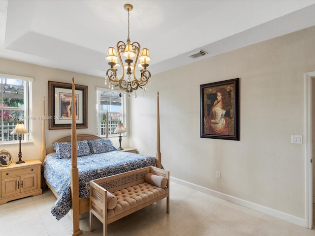 bedroom featuring a raised ceiling, multiple windows, and a notable chandelier