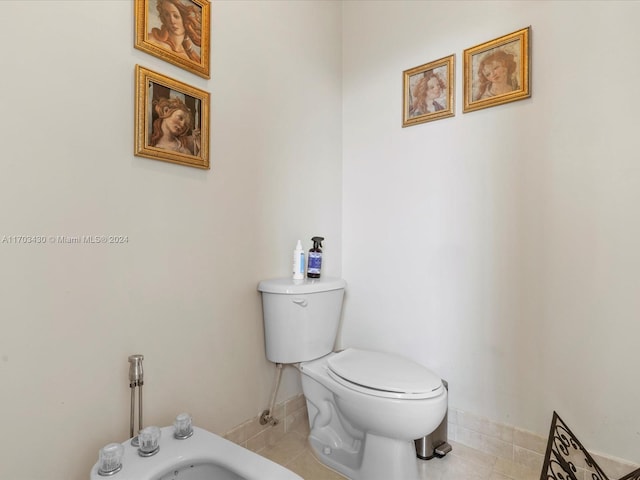 bathroom with tile patterned floors, toilet, and a bidet