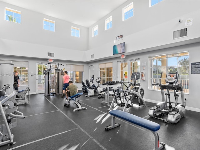 gym with a towering ceiling