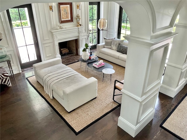 living room with dark hardwood / wood-style flooring and a healthy amount of sunlight