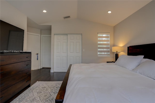 bedroom featuring lofted ceiling, recessed lighting, dark wood-type flooring, visible vents, and a closet