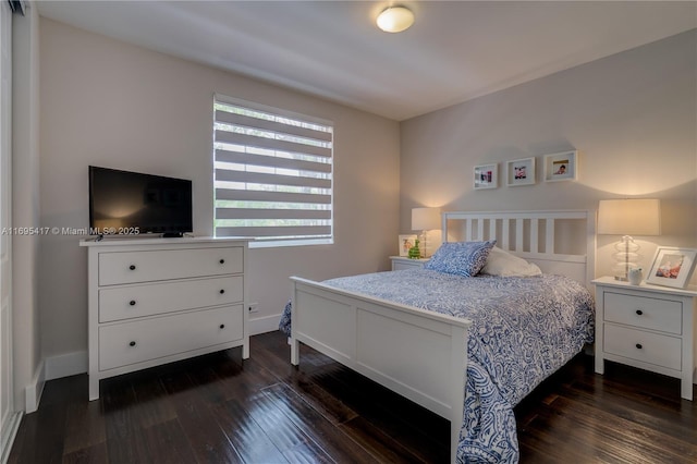 bedroom featuring baseboards and dark wood finished floors