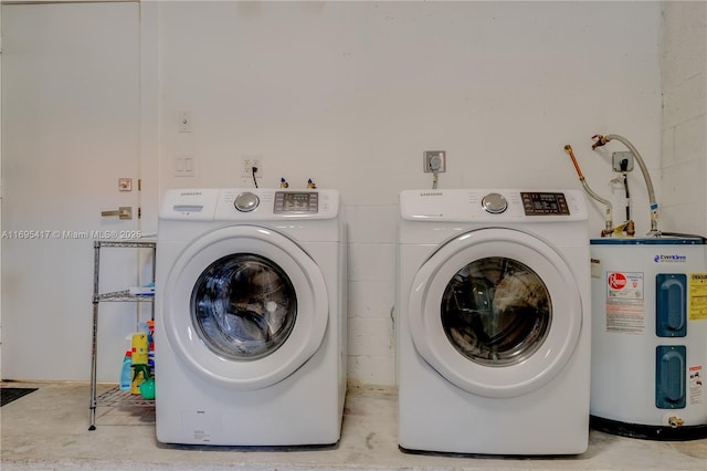 washroom with laundry area, washer and dryer, and electric water heater